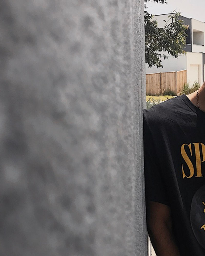 Detail of a Spacely tee against a concrete wall
