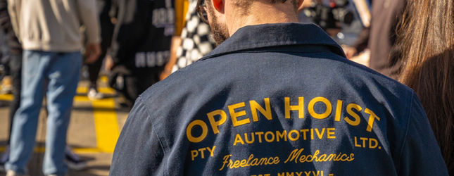 Open Hoist Automotive work jacket seen from behind in the crowd