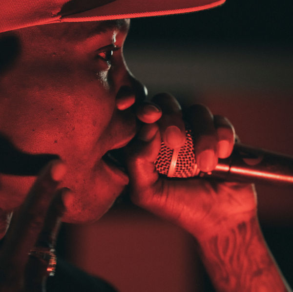 Close-up of an artist on the microphone under red light