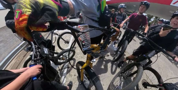 Rider reaching down to the handlebars mid-ride