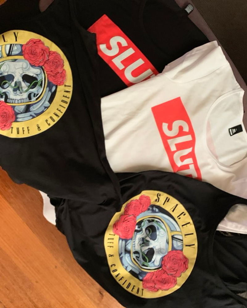 Spacely slipmats, tee and stickers arranged on a table