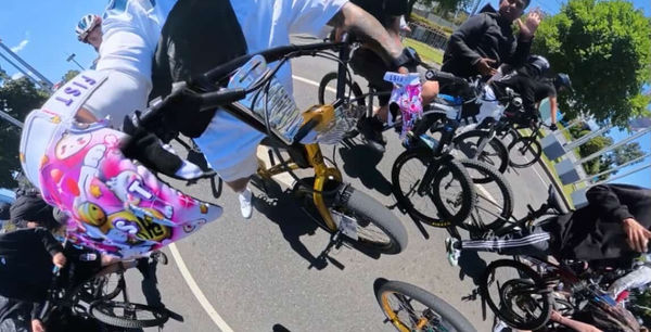 Custom bike with pink graphics parked among the group