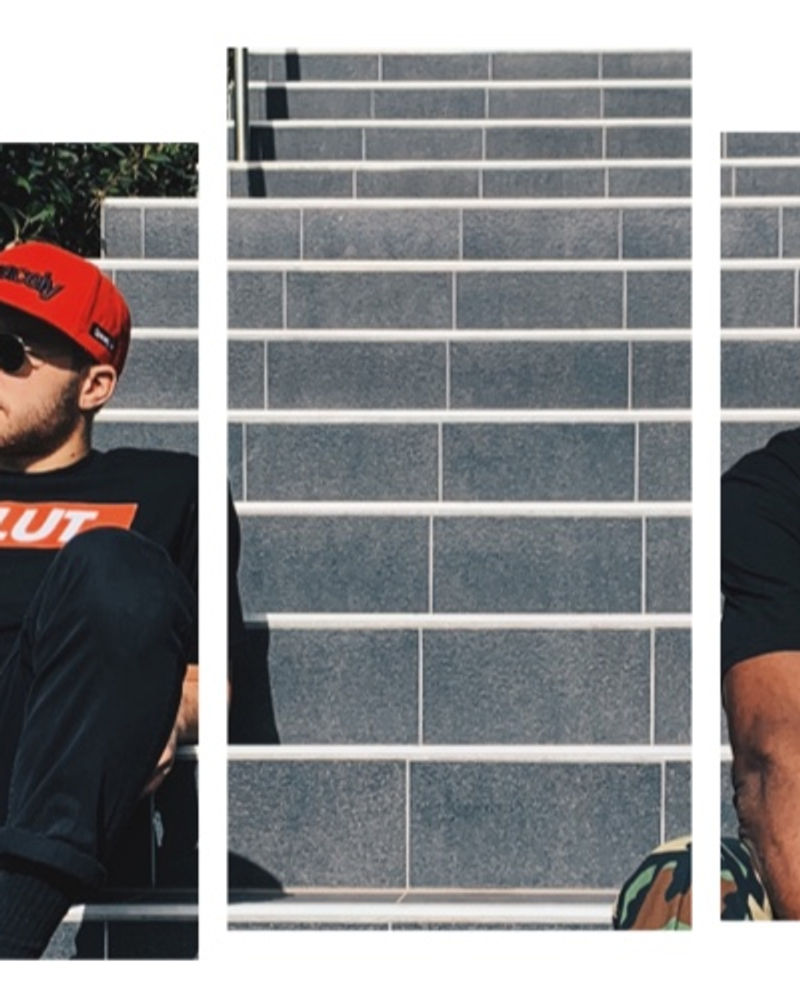 Two figures in Spacely caps in front of a stairwell