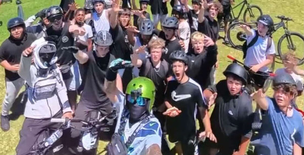 Crowd of riders cheering with their bikes raised