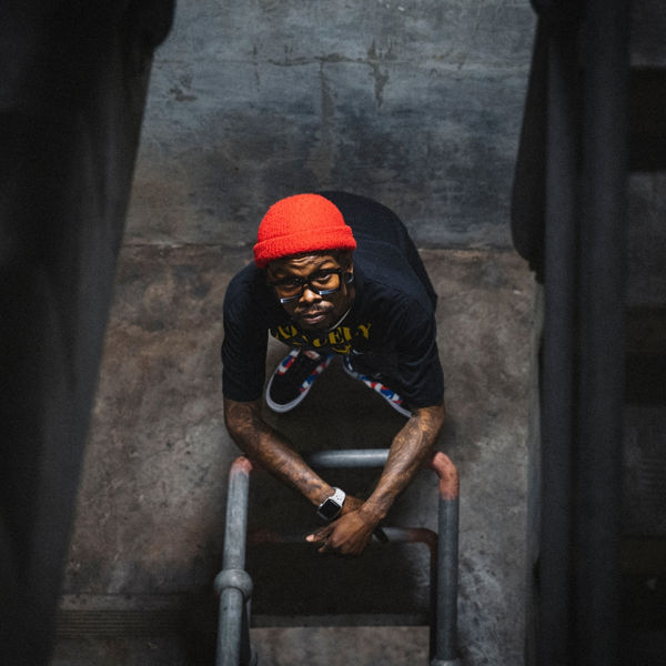 Model in a red beanie shot from above on a stairwell