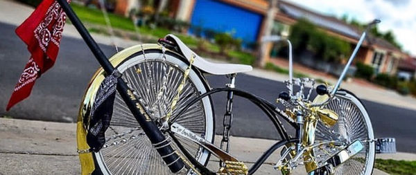 Lowrider bicycle flying a red bandana flag on a suburban footpath