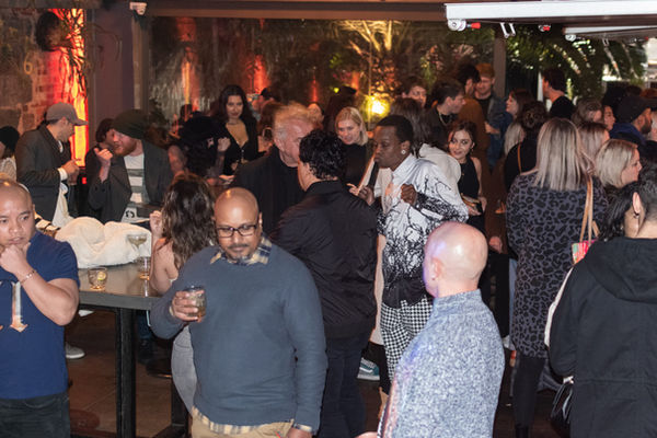Crowded industry event with people talking in groups