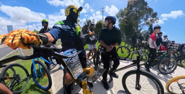 Rider pulling a wheelie in front of the group