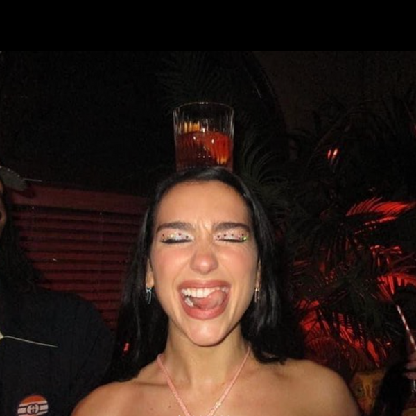 Woman balancing a cocktail glass on her forehead