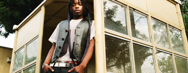 Model in a Spacely vest outside a weatherboard building