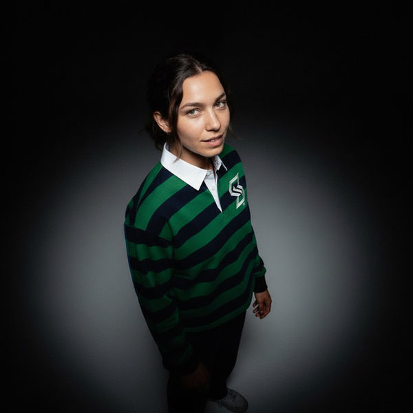 Portrait of a woman in a green and navy Spacely rugby top