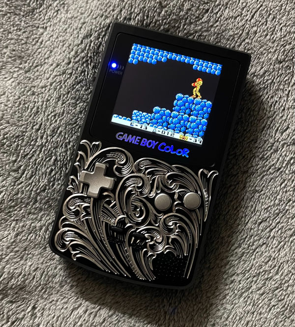 Game Boy Color fitted with a hand-engraved metal shell
