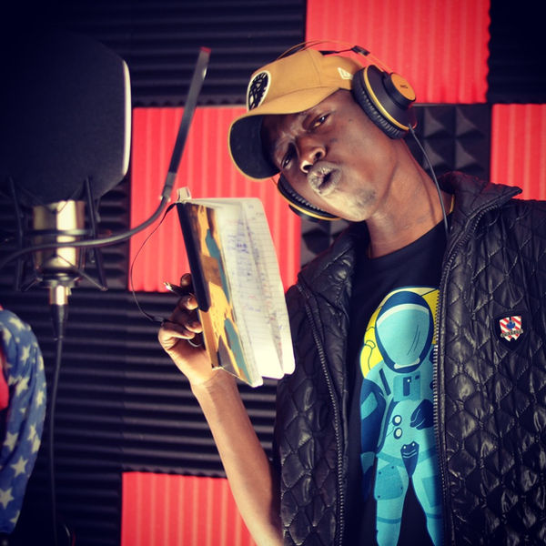 Artist in a Spacely astronaut tee recording in a vocal booth