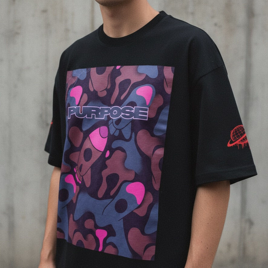 Model in a Spacely tee with pink and purple camo globe print