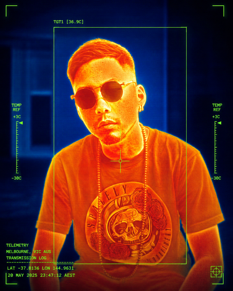 Thermal-imaging portrait of a person in sunglasses and a Spacely tee