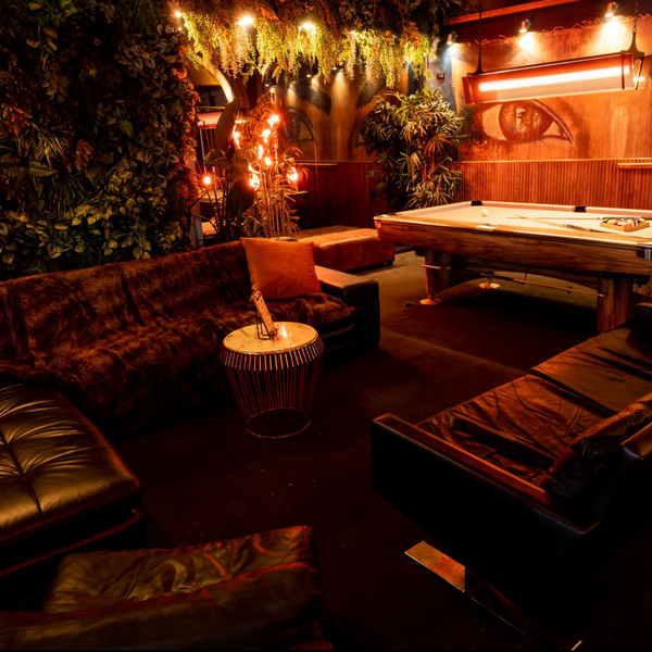 Leather booth seating and pool table in the Electric Bar lounge