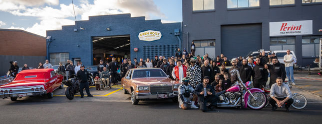 Crowd and lowriders filling the Open Hoist Automotive forecourt