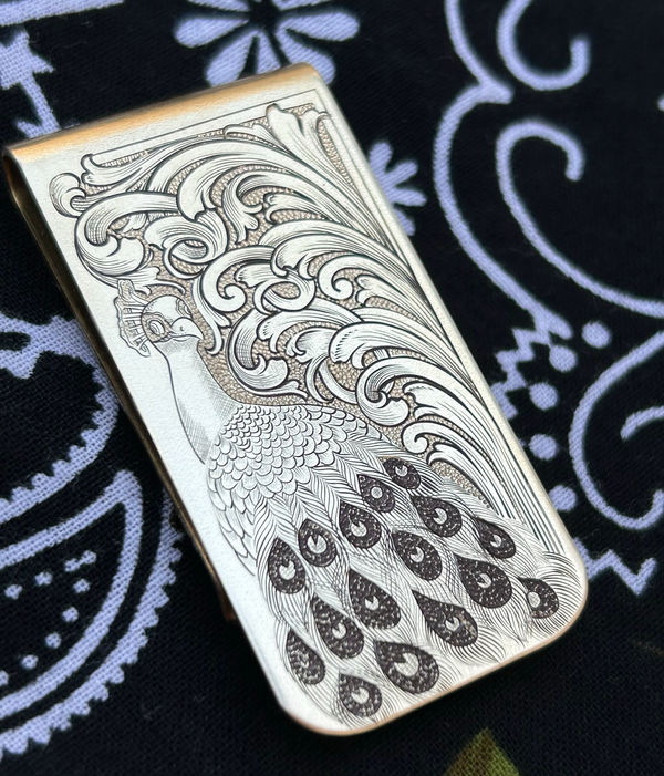 Engraved silver money clip with a peacock motif