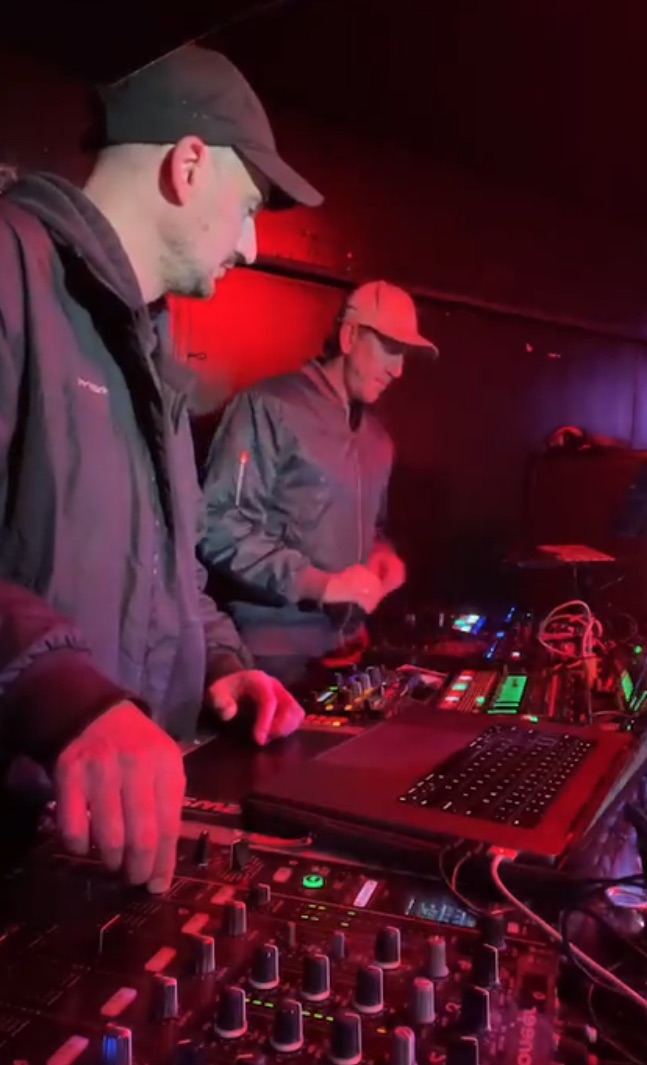 ILL EAGLE DJS mid-set in a red-lit room