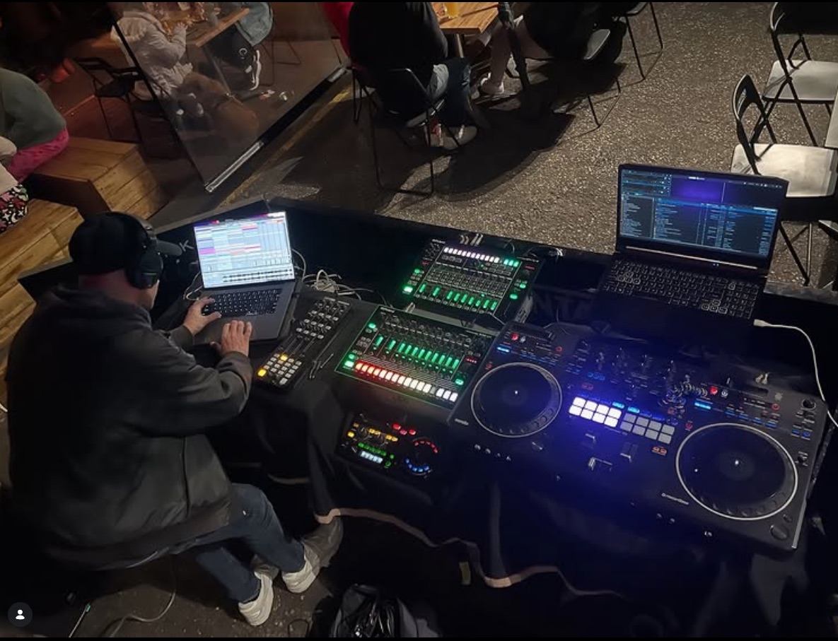 The full ILL EAGLE DJS rig from above — laptops, drum machines and decks in front of a crowd