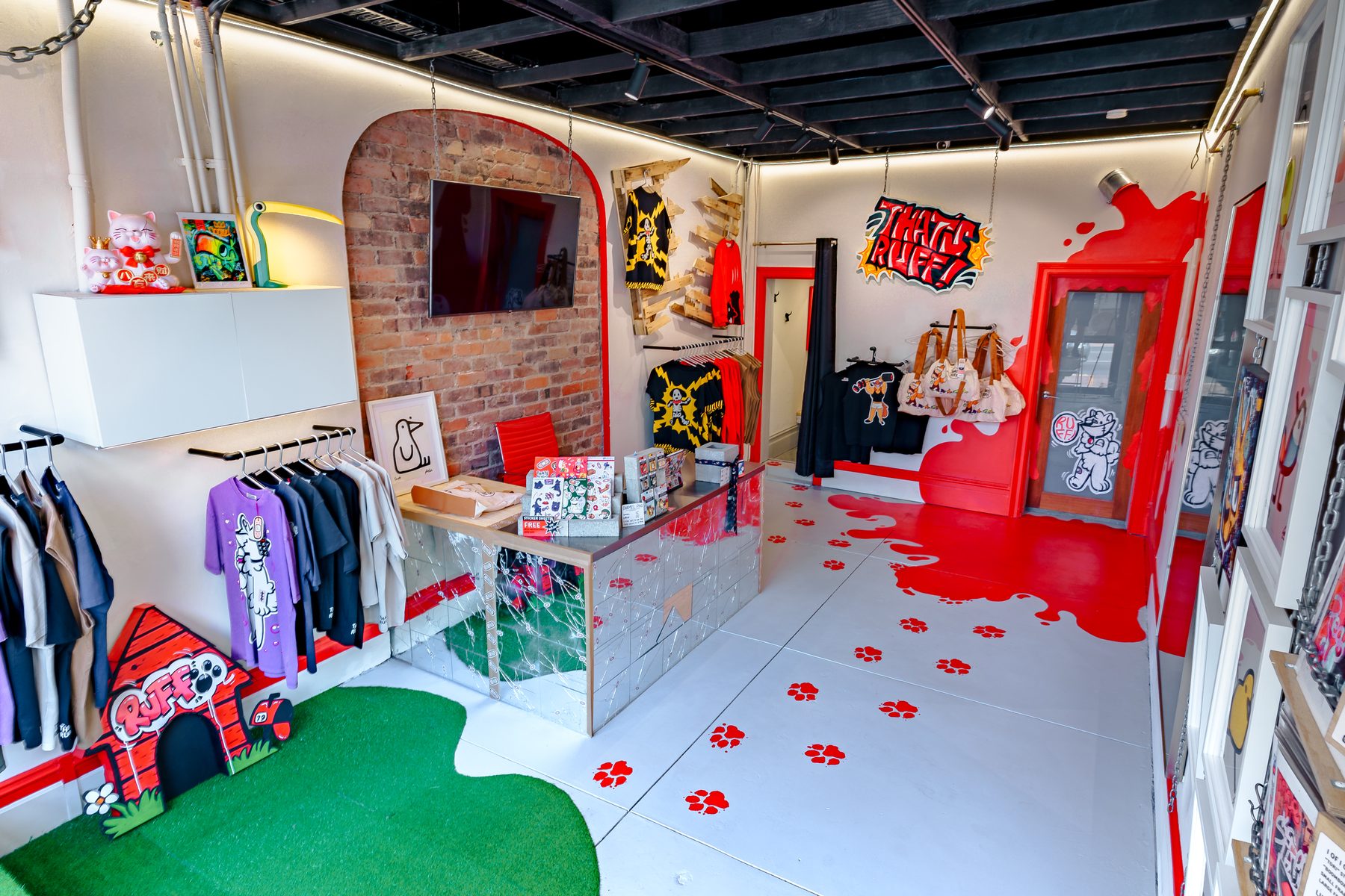 Inside the Collingwood store — paw prints across the floor, a dog house, racks along the wall